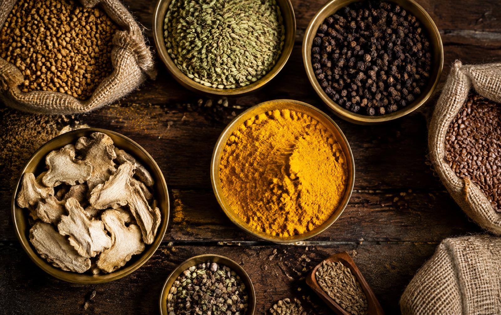 Brass bowls of fenugreek, fennel, peppercorns, turmeric and dried ginger